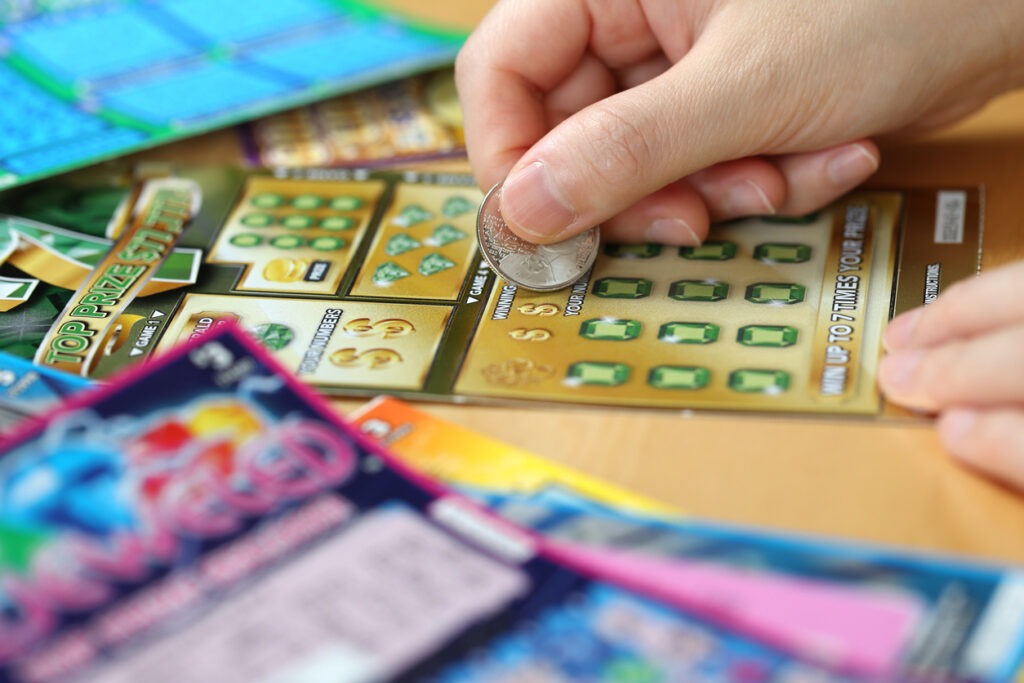 An image of A person scratching a scratch card