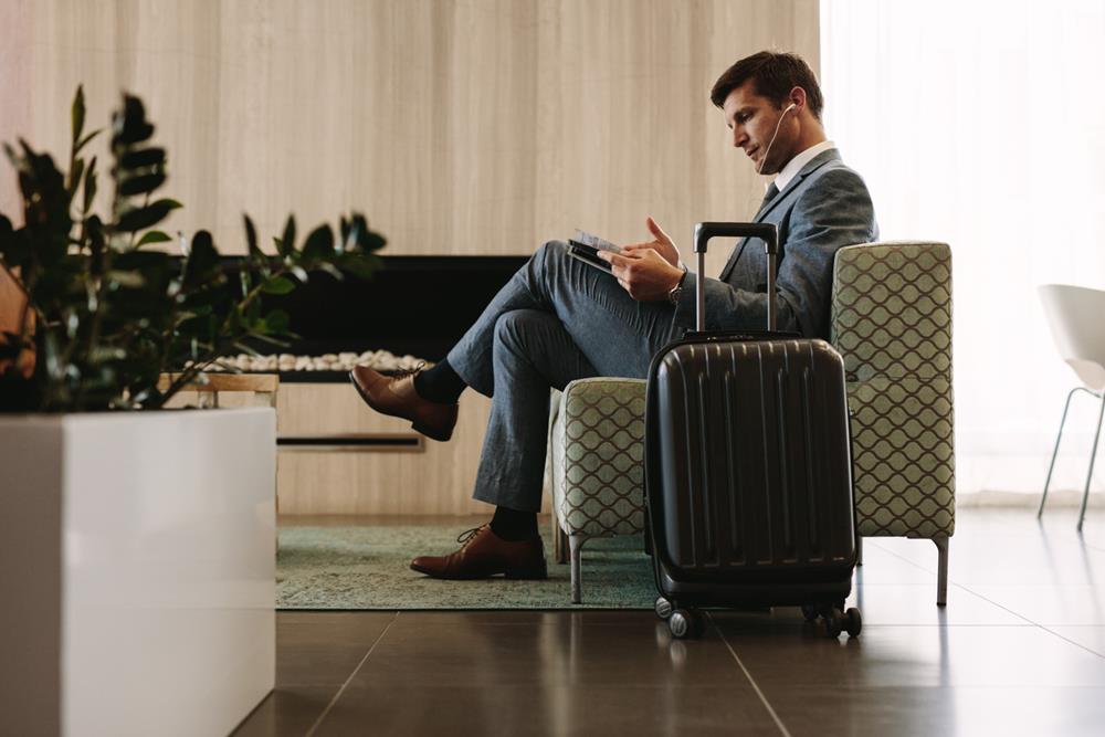 Businessman reading in the waiting area of an airport