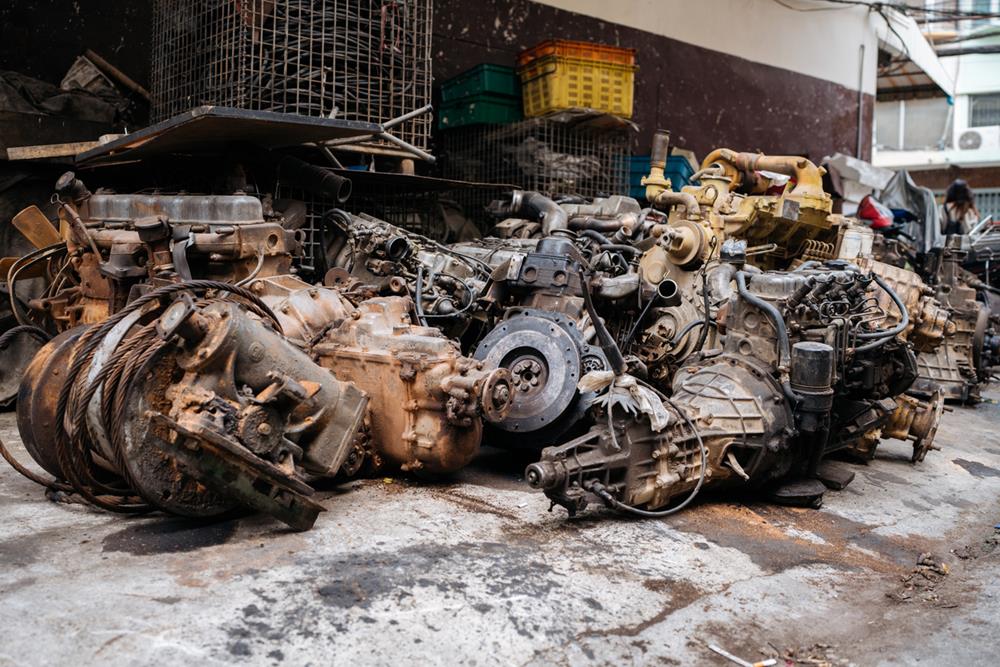 Engine and other car parts in a junkyard