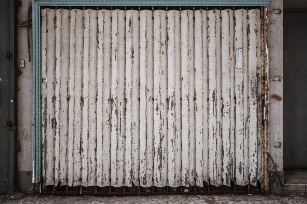 worn-out white metal garage door image