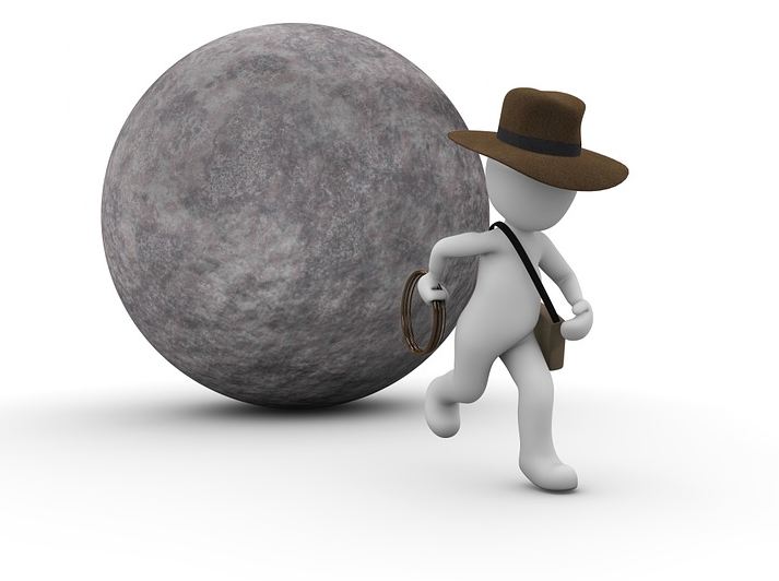 Indiana Jones running away from a boulder