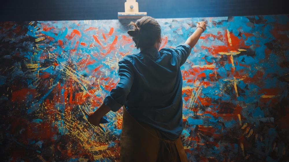 Artist painting an abstract art