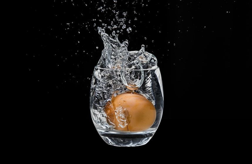 egg thrown into a glass of water