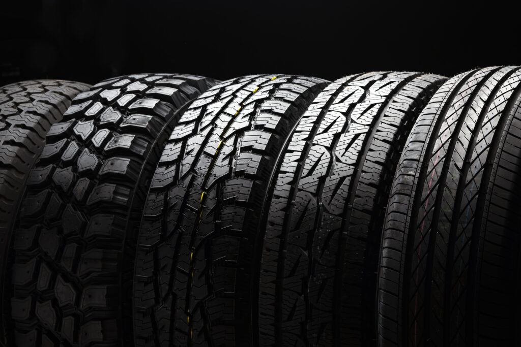 All-terrain tires lined up in a row against a dark background