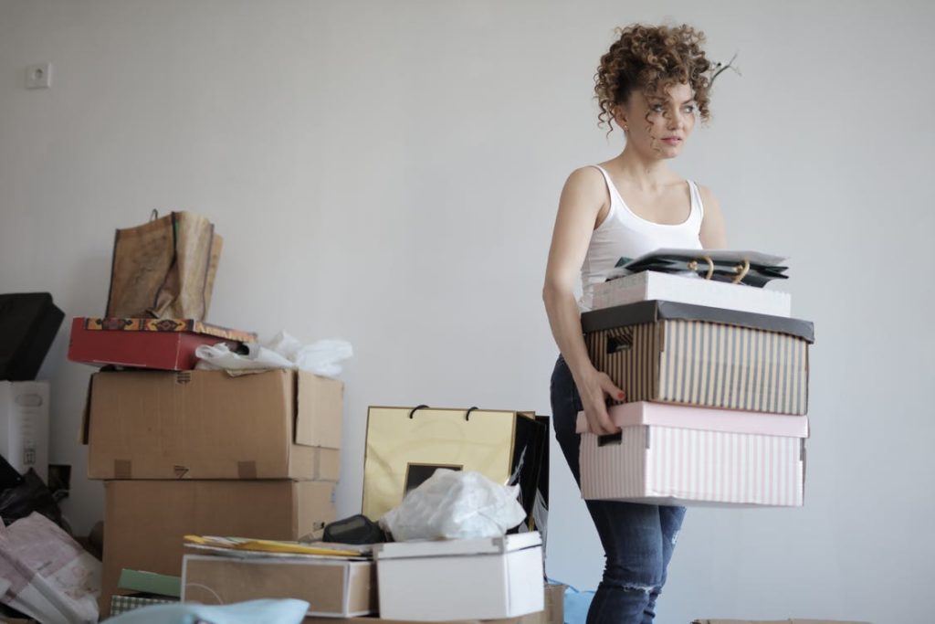 woman carrying boxes for moving