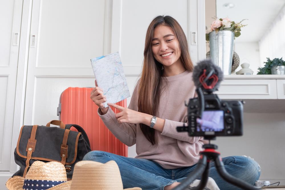 Woman recording a video about her travel plans