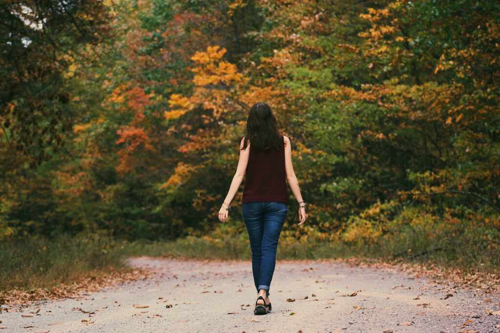 A woman walking in a park image