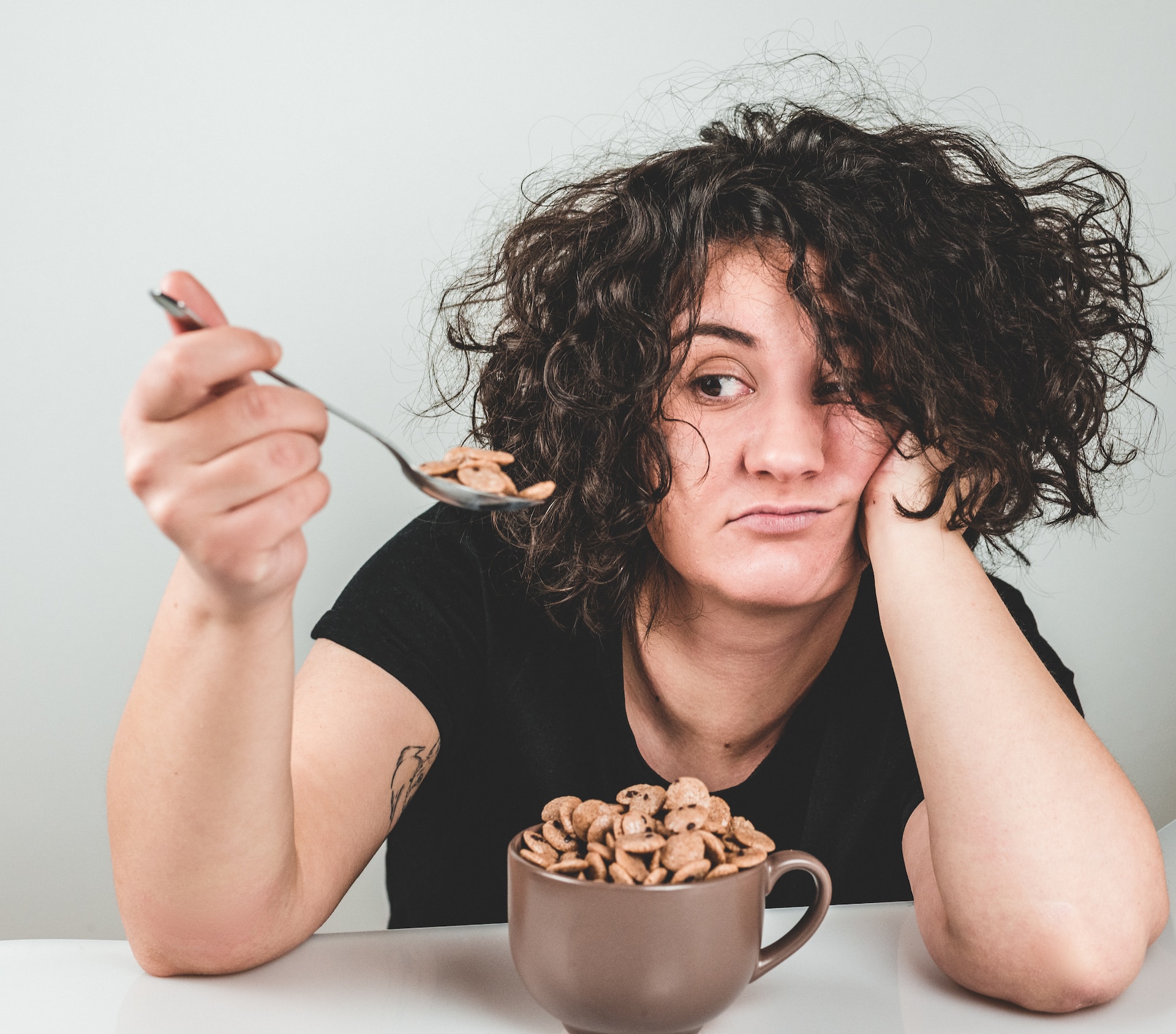 woman holding a spoonful of cereal