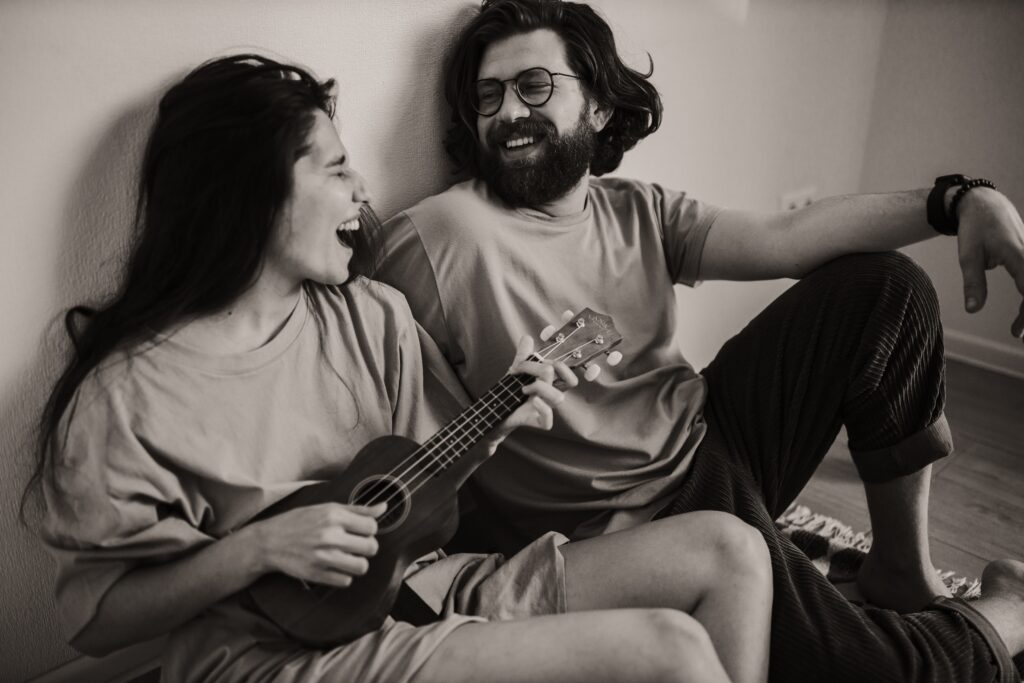 couple sitting on the floor playing a song image