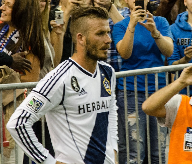 David Beckham at a match, with spectators behind him