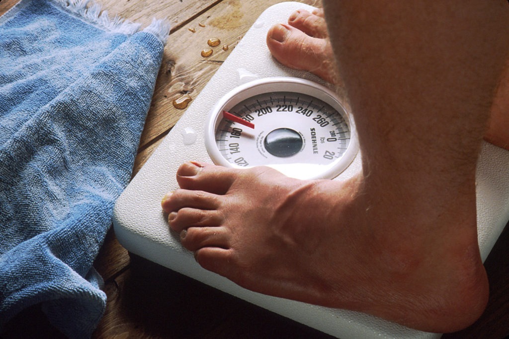 A mechanical bathroom scale. Pressure on the internal springs rotates a disc displaying the user’s weight in pounds