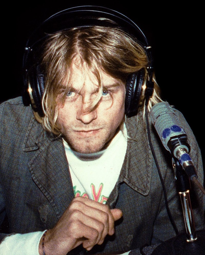 Kurt Cobain wearing headphones and having a microphone