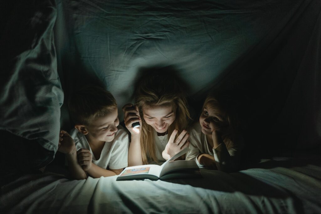 Mother and kids reading a book image