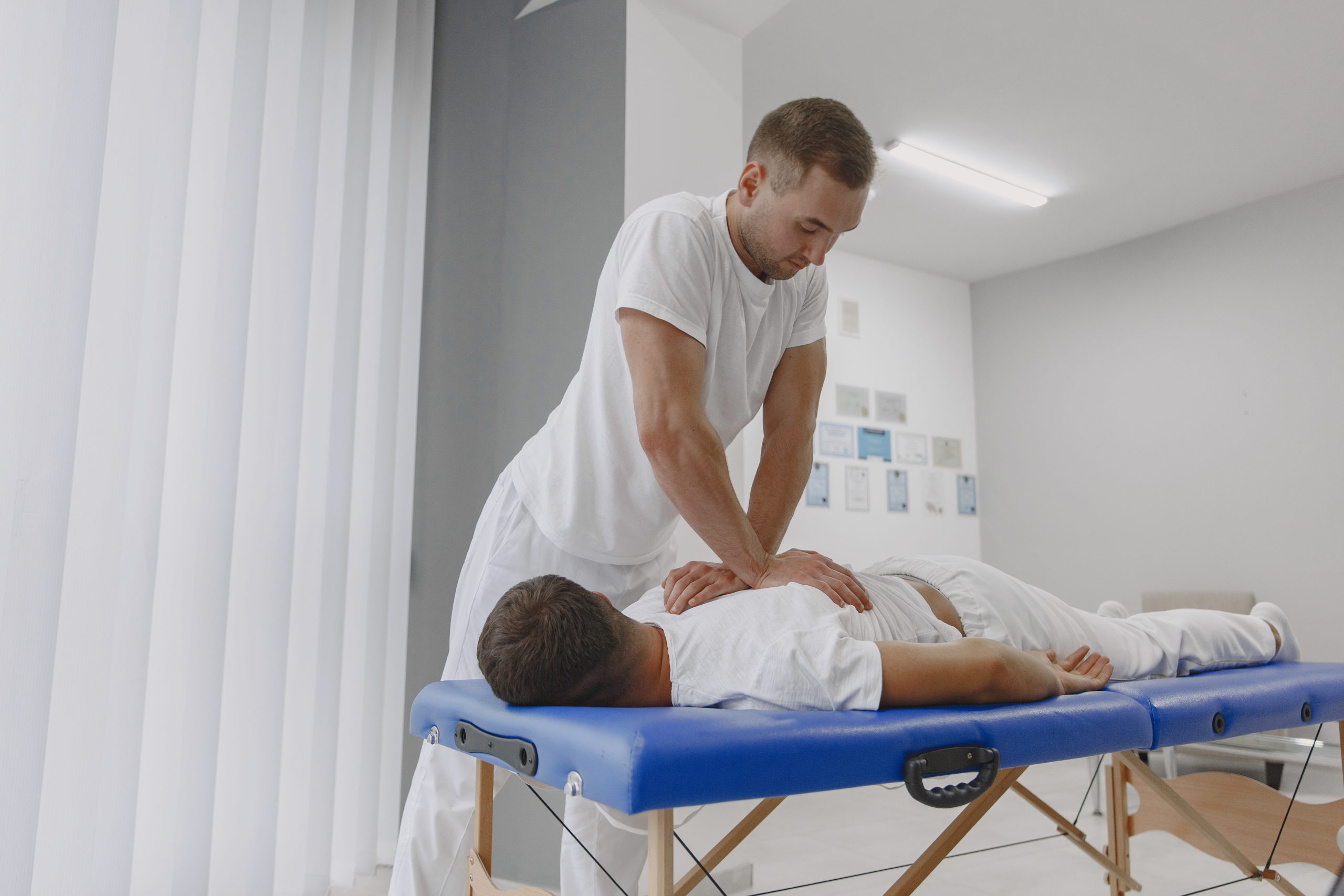 Male physiotherapist massaging man's back