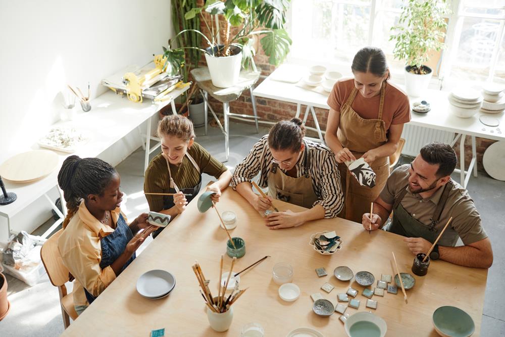 People designing pottery in an art studio