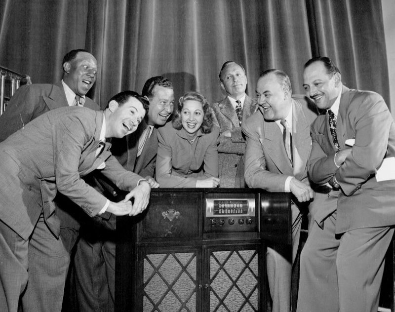 Mel Blanc posing with the cast of The Jack Benny Program