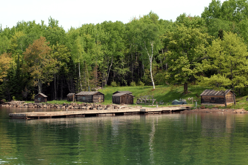 Picture of huts nearby a river.