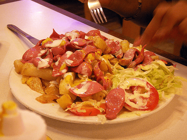 a plate of sausages and potatoes