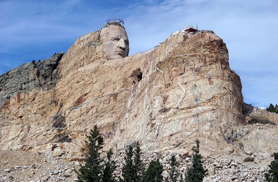 a sculpted head on top of a rock