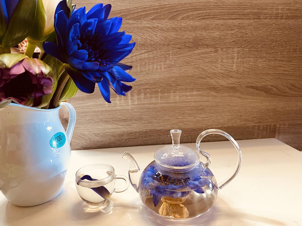Fresh lotus tea in a glass kettle