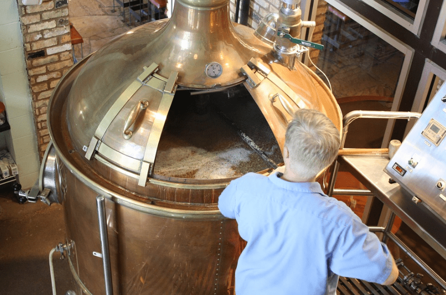 man making beer in a brewery