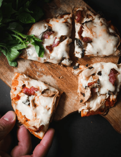 slices of pizza in a wooden paddle