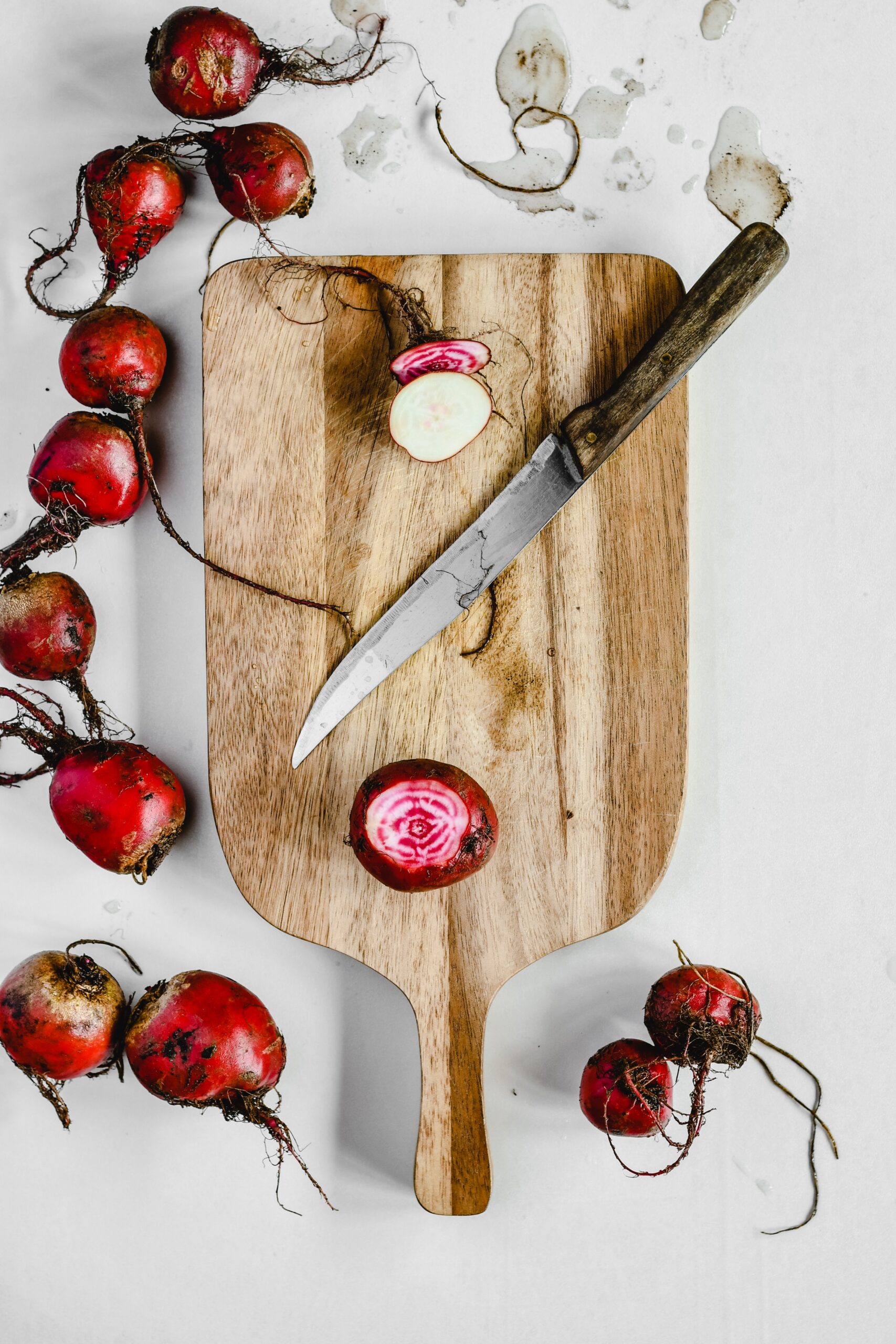A cutting board surrounded by beetroots image
