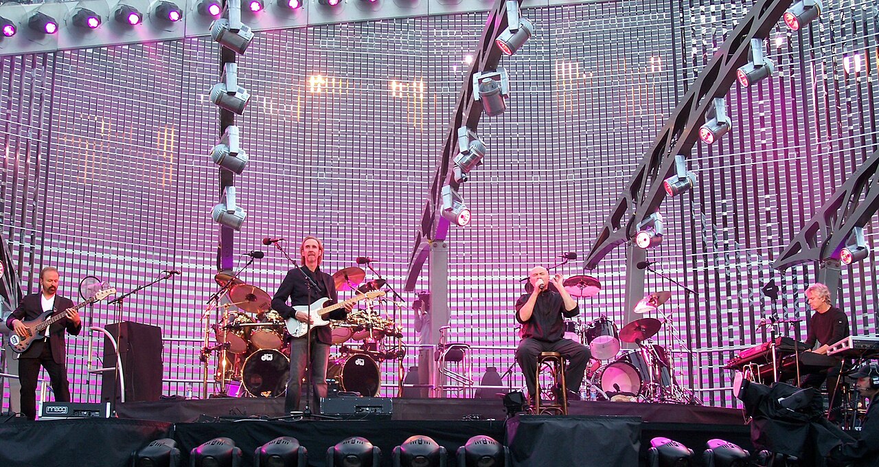Genesis performing at Old Trafford, Manchester in 2007. From left to right, Daryl Stuermer on bass, Mike Rutherford on guitar, behind him Chester Thompson on drums, Phil Collins on vocals and Tony Banks on keyboards