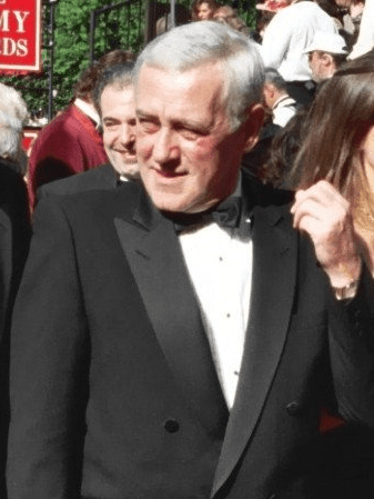 John Mahoney wearing a black suit on an event 