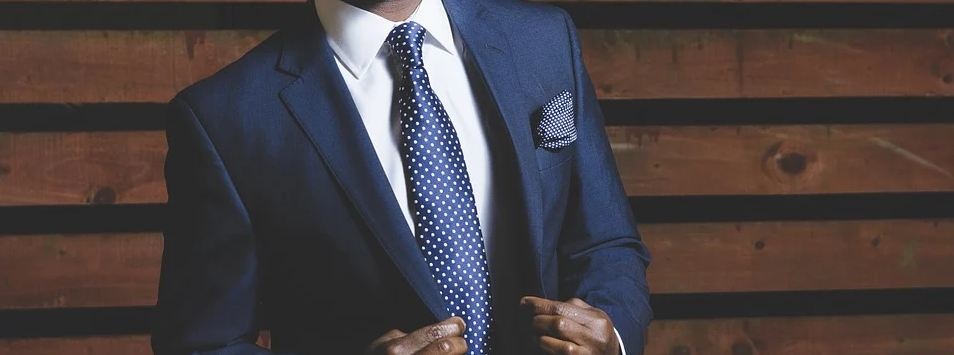 Man in a blue suit and blue polka dot tie