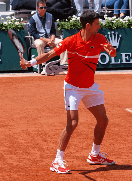 Novak Djokovic wearing Asics shoes at a clay court