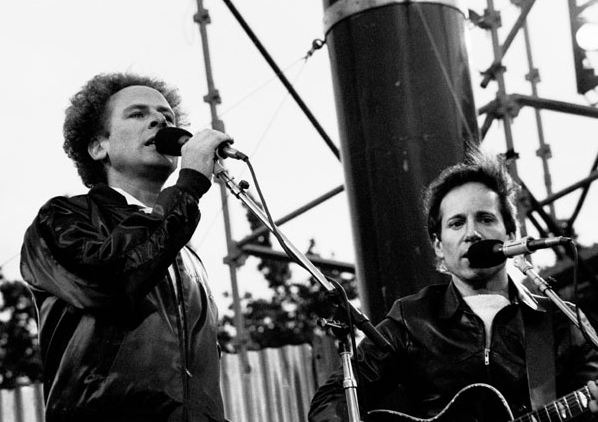 Simon & Garfunkel singing in a concert.