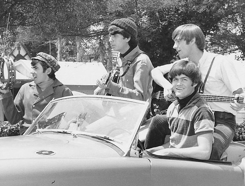 The Monkeys playing instruments while riding a car