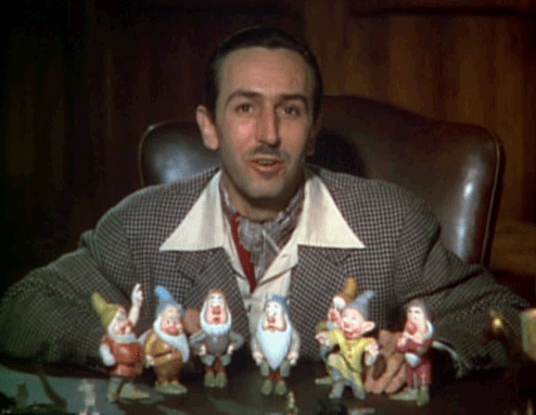 Walt Disney with the miniature toy dwarfs