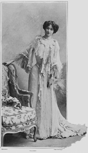 a black-and-white photograph of a woman in tea gown