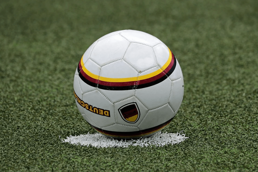 a football on a white patch on the field