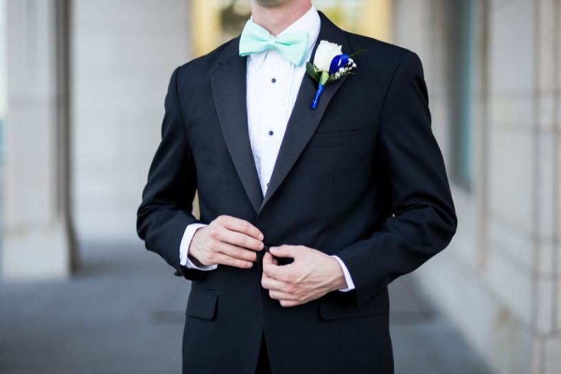 a man wearing a black-and-teal tuxedo