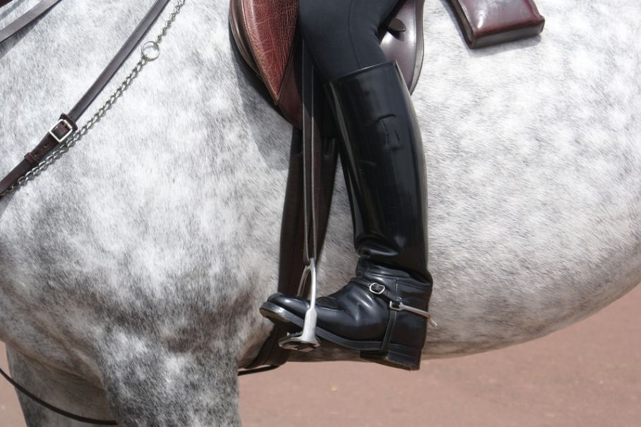 a riding boot worn by someone mounting a horse