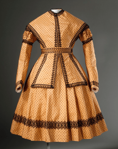 a young girl’s dress with pelerine