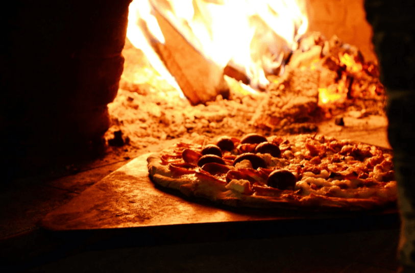 cooking pizza in an oven