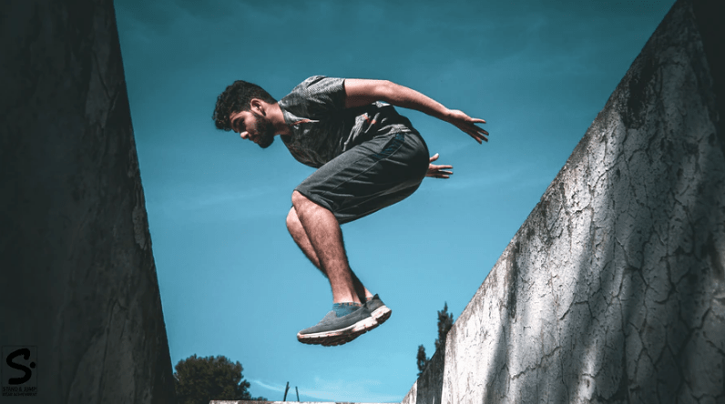 man leaping on walls