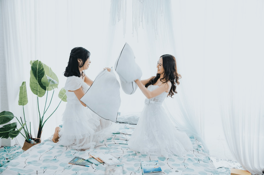 two women pillow fighting