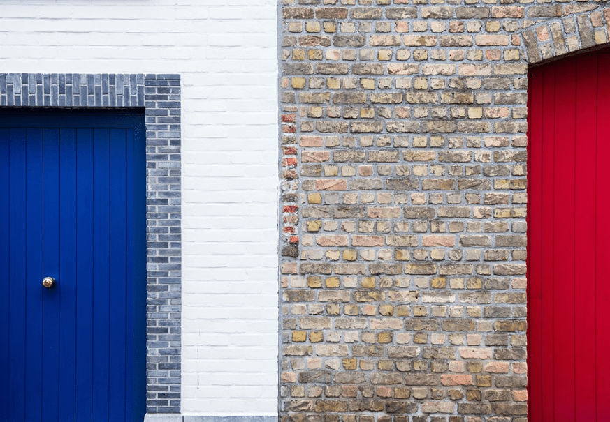 white wall, blue door, brick wall, red door