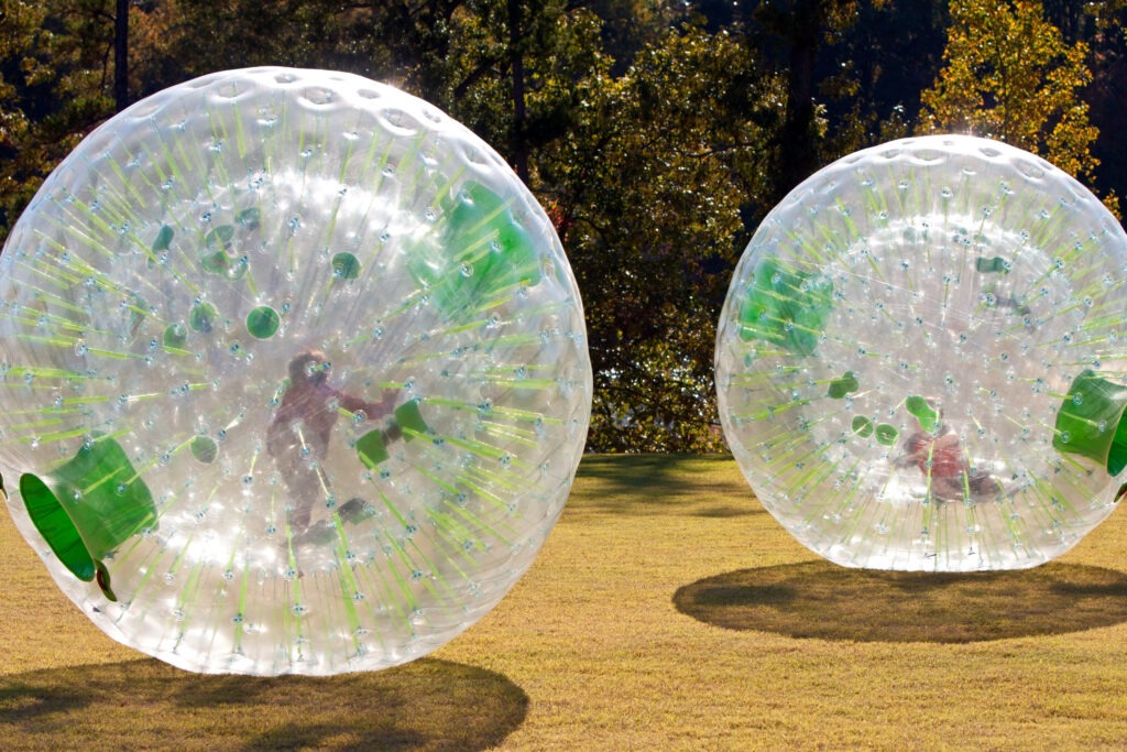 Kids rolling inside a zorb ball