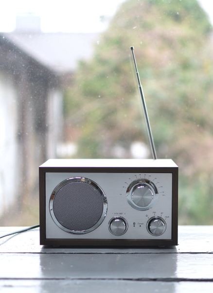 A silver retro radio set on a window sill 