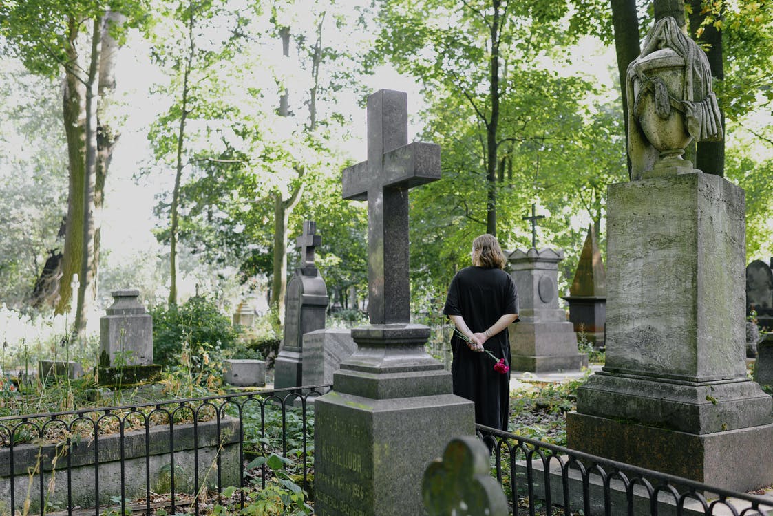 a woman standing in a cemetery