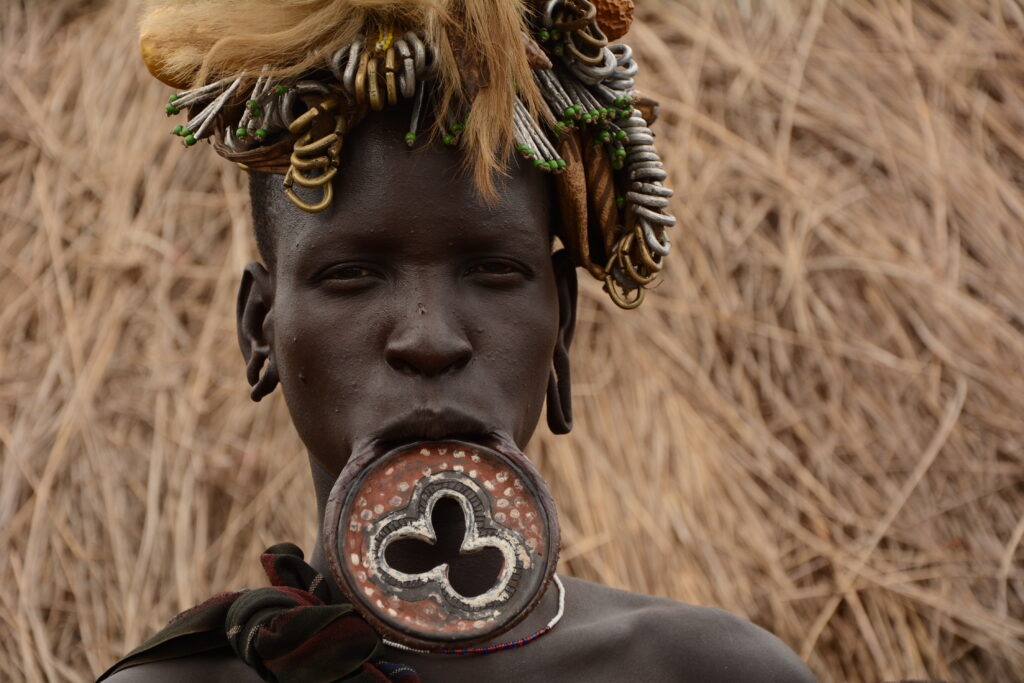 African with a lip plate that has a clove-like ornamental in it