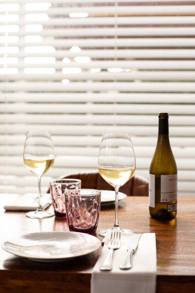two glasses of clear wines on a table image