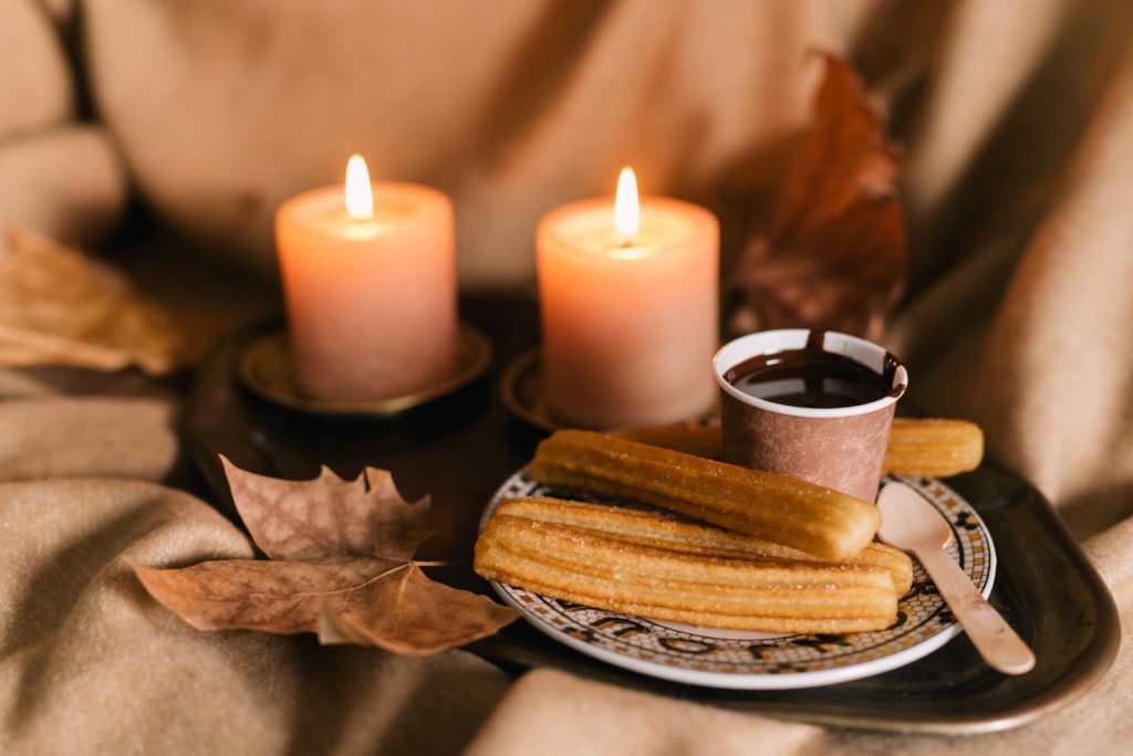 A churros with lighted candles