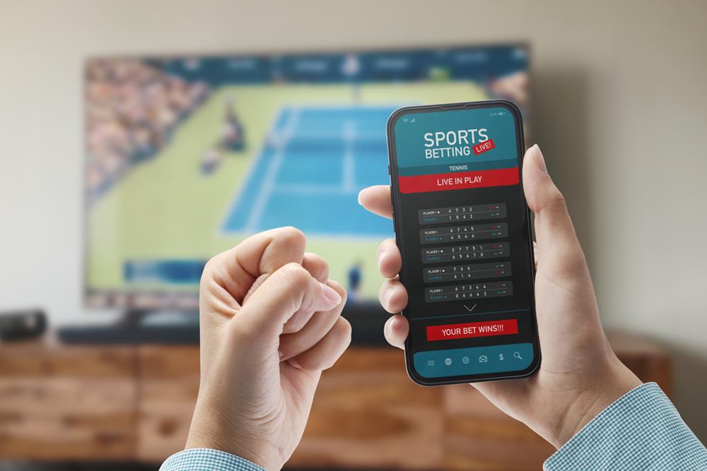 Person betting on sports using a mobile app